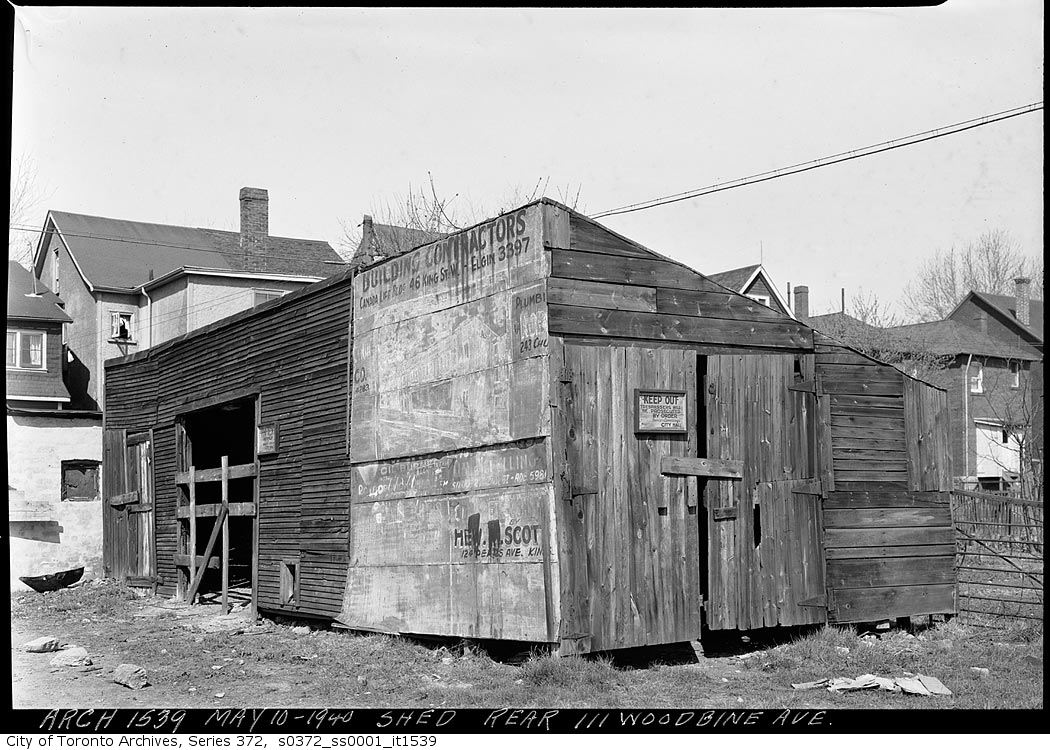 Shed at the rear of 111 Woodbine Avenue, Toronto, #OnThisDay in 1940 (May 10) It appears that a section of this little old shack out back was made of recycled billboards. #otd #1940s #laneways #sheds #garage #history #torontohistory #tdot #the6ix #toronto #canada #hopkindesign