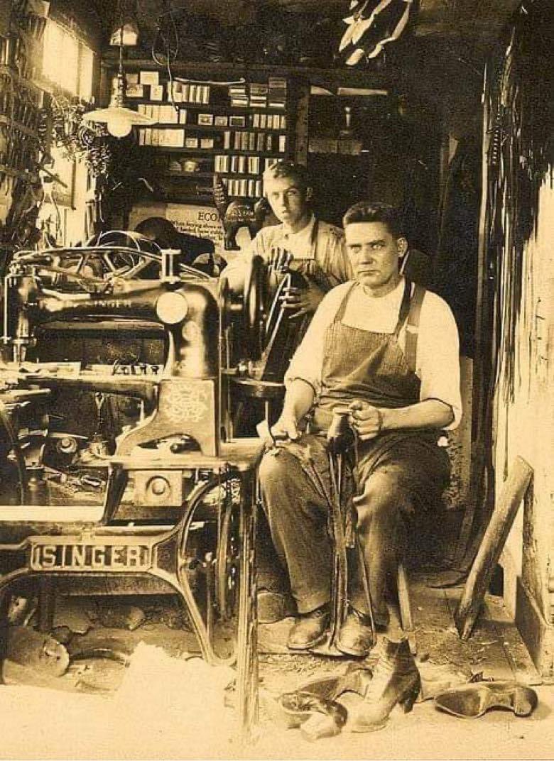 Dad with son in his shoe repair shop, Connecticut, early 1900's. Lost art now Throughaway society!