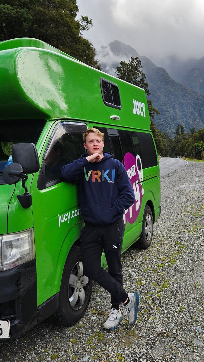 ItsKittenDev's tweet image. Oh hey it's been a sec internet! 
New Zealand was gorgeous.
Very convenient weather to pose for a dumb fake campervan ad in your @ElliottVenczel merch.

(Now back to making cool stuff &amp;gt;:))