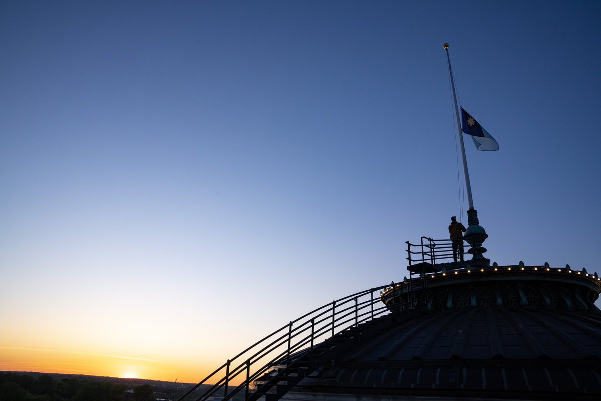 The former Minnesota state flag is lowered for the final time during a pre-dawn ceremony at the MN State Capitol. Shortly after at sunrise, the new state flag was raised for the first time.