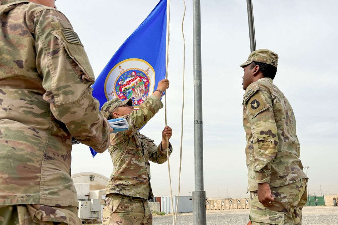 The 34th Red Bull Infantry Division, the first Minnesotans to legally fly the new State flag on a military installation, honor this historic moment in the U.S. Central Command area of operations.