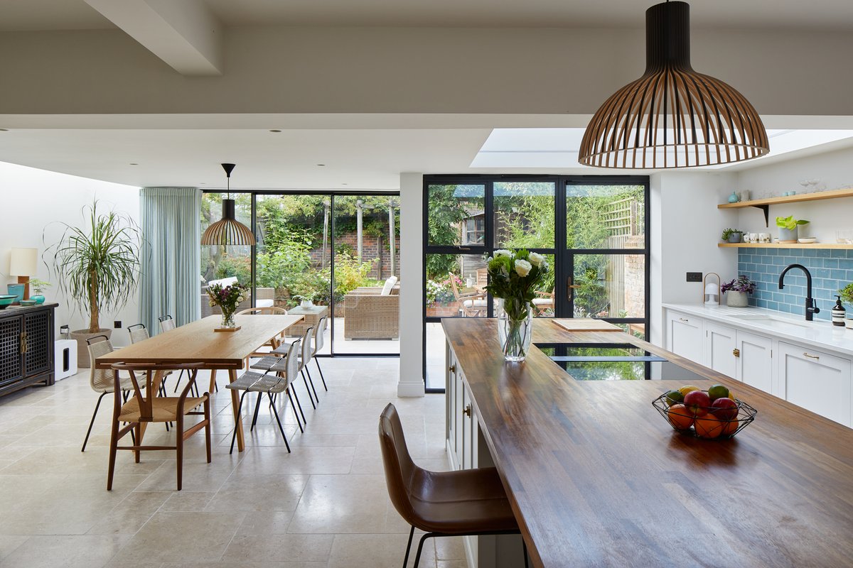 Slim sliding doors mixed with steel look patio doors create a light filled kitchen extension in St Albans. Check out the full case study to see how we made these two systems work in harmony iqglassuk.com/projects/alma-…