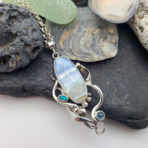 Solway Storm A naturally occurring storm in a piece of Owyhee jasper. To compliment the stormscape I added some flowing silver seaweed, finished the pendant with a dusky Santa Maria aquamarine and an Australian black opal. emmascottjewellery.com/product-page/s… #UKGiftHour #UKGiftAM #MHHSBD