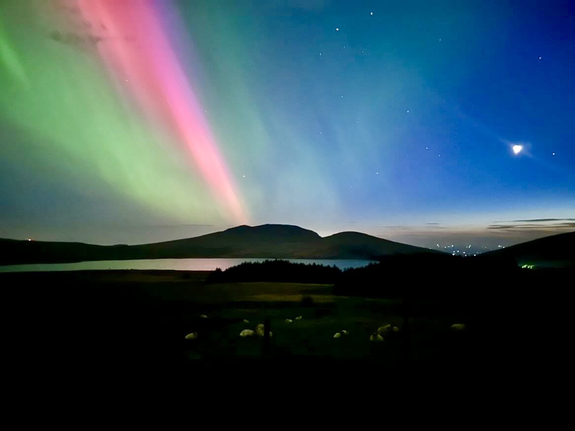Check out this stunning view over The Mourne Mountains last night! 🌌 Did you catch a glimpse of the Aurora Borealis? Share your favorite shots below! ✨ Image by: @charolette_knox #NorthernLights #MourneMountains #nationaltrustNI #nationaltrust