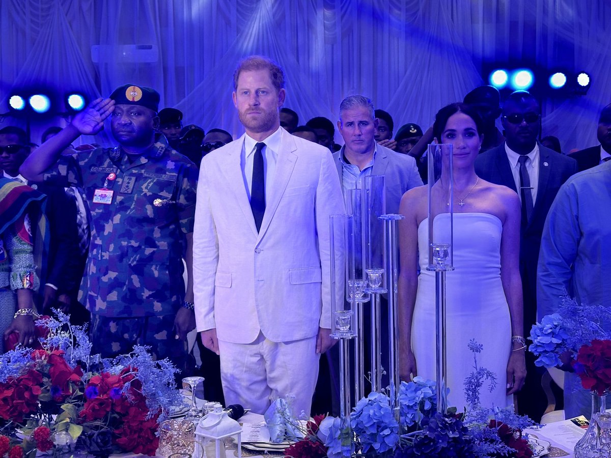 The couple then attended a reception hosted by the military’s Chief of Defence Staff (who is behind their visit to the country). Here they are standing while the Nigerian anthem is being played.
