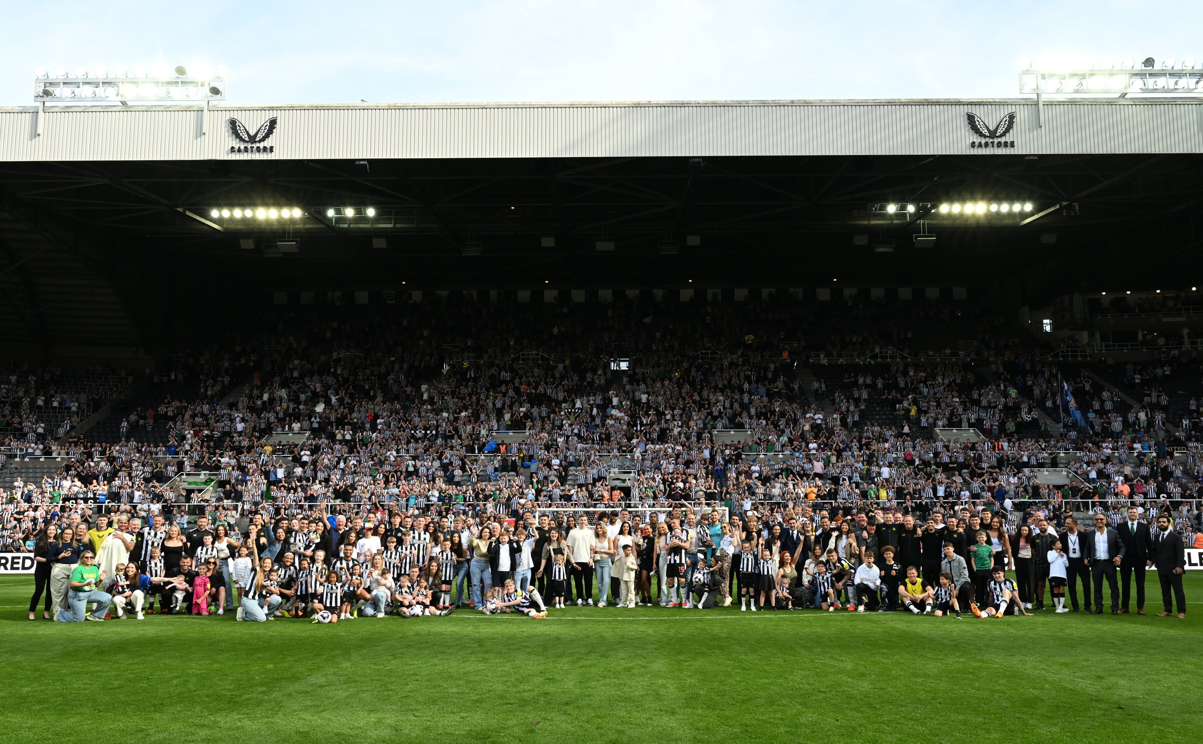 A wide shot of the Newcastle United players and their families in front of the Gallowgate Stand following our last home fixture of the season.