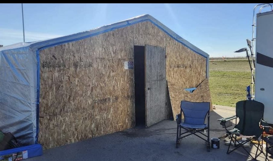A tale of two protest encampments. Police tear down a temporary pallet fence at the U of C protest for Palestine, while the anti-carbon tax structure is left alone for well over a month &amp; even gets a full sized door. Never mind it's in the way of semi parking. #ableg