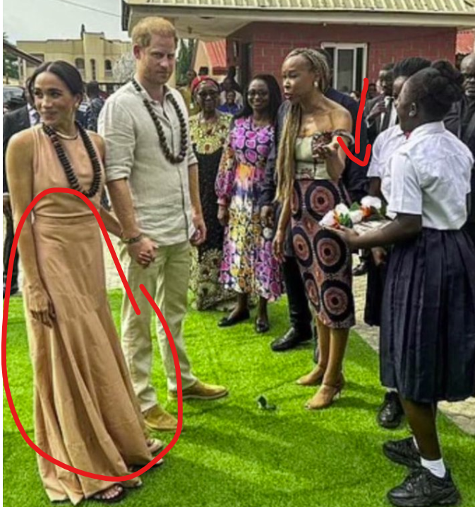 the grifter wearing a rag is ignoring the young student who is there to welcome her. What a mess!! #MeghanMarkleAmericanPsycho #MeghanMarkleIsAConArtist #DumbPrinceAndHisStupidWife
