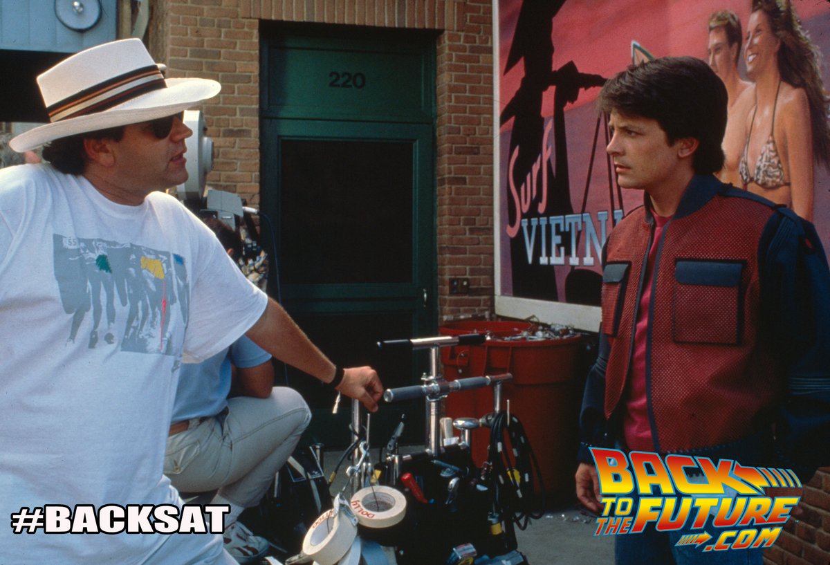 It's #BACKSAT and this BTS pic comes from @BacktotheFuture Part II with Director Robert Zemeckis and Michael J. Fox on the 2015 set. For all things #BTTF visit BacktotheFuture.com