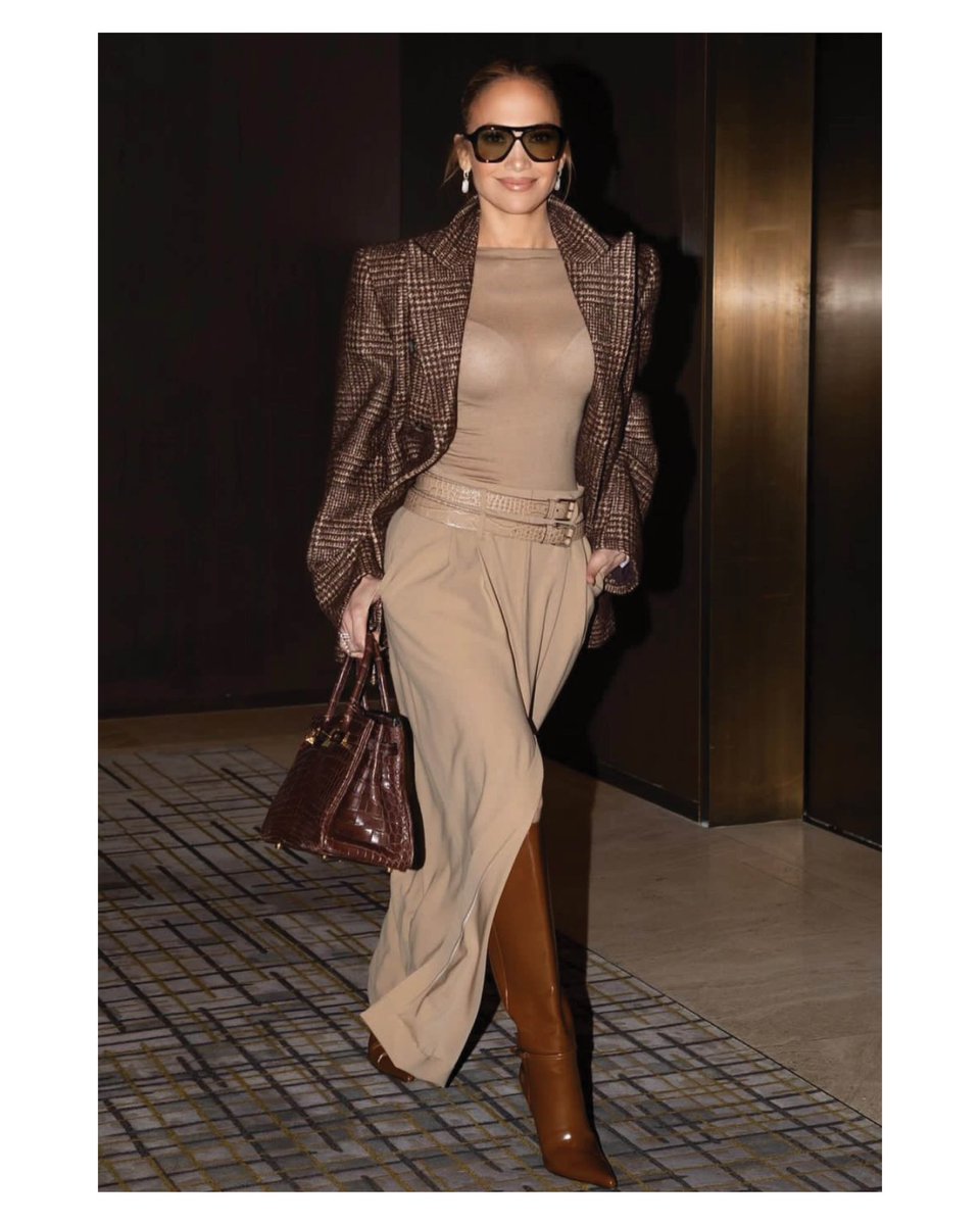#JenniferLopez steps out in New York City wearing a glen plaid silk-and-wool tweed blazer with a wool serge trouser skirt, both from the Fall/Winter 2024 #MichaelKorsCollection.