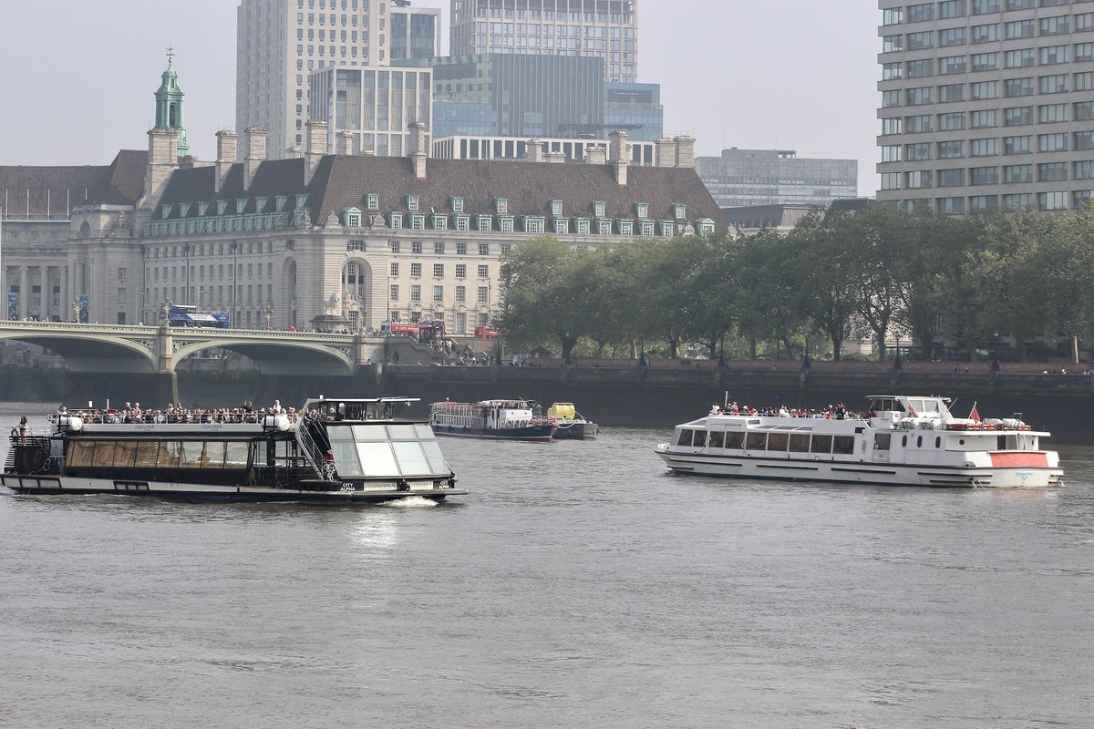 Traffic on a misty River Thames this morning.