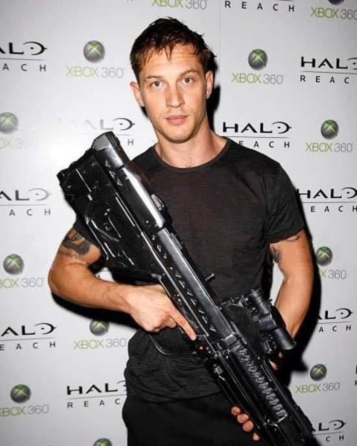 Tom Hardy holding a DMR from Halo. This is a pic of him at the midnight release launch party.