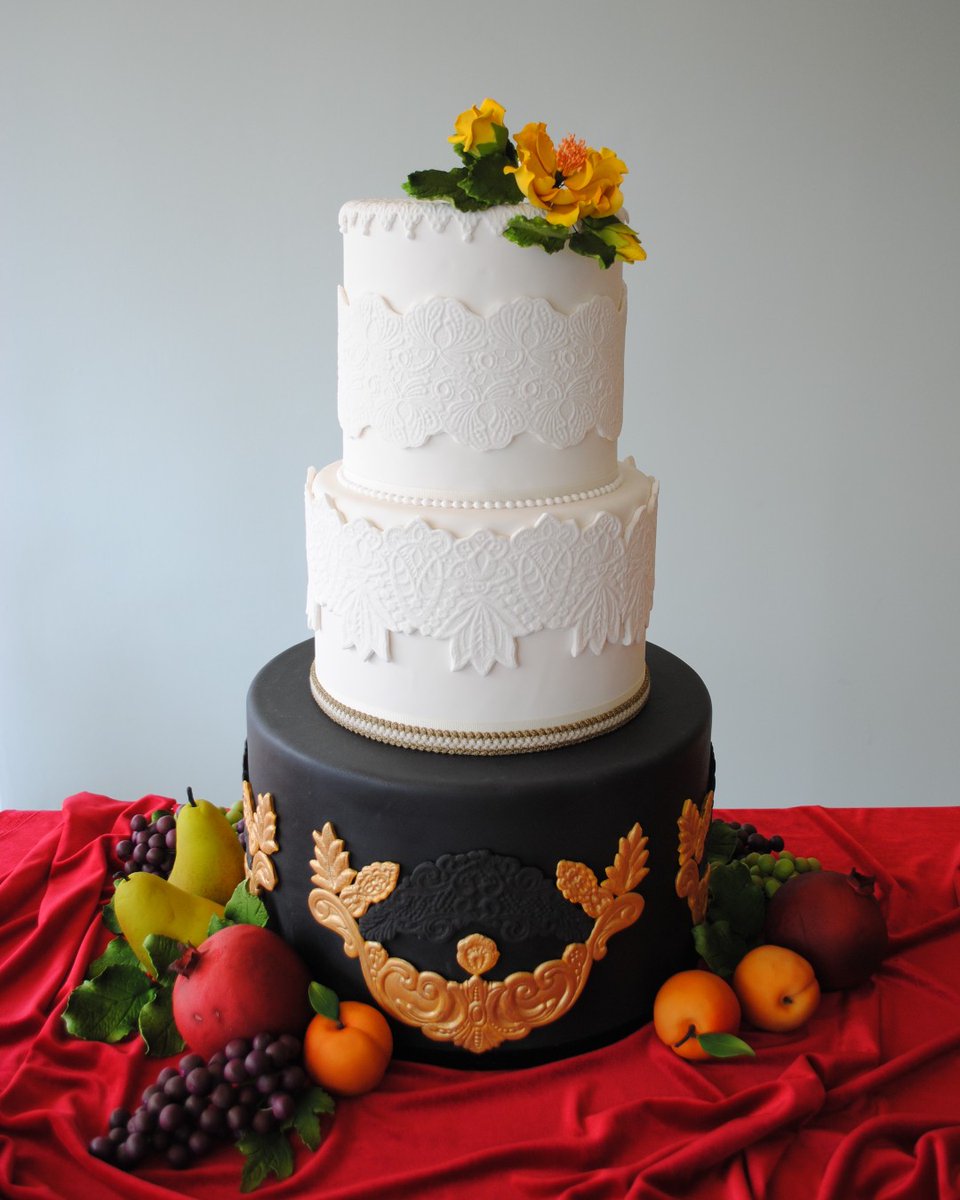 Feast your eyes on this elegant moment! Details created in gumpaste, with piped edging and airbrushed sugar flowers. #customcake #cakeoftheday #cake #charmcitycakes #cakeart #weddingcake #wedding #tieredcake #weddinginspo #sugarflowers #sugarart