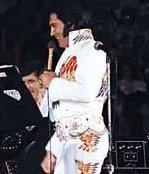 May 11, 1974;
Elvis Presley at the
Los Angeles Forum in California. Evening show wearing the American Eagle jumpsuit.
#ElvisPresley #ElvisHistory