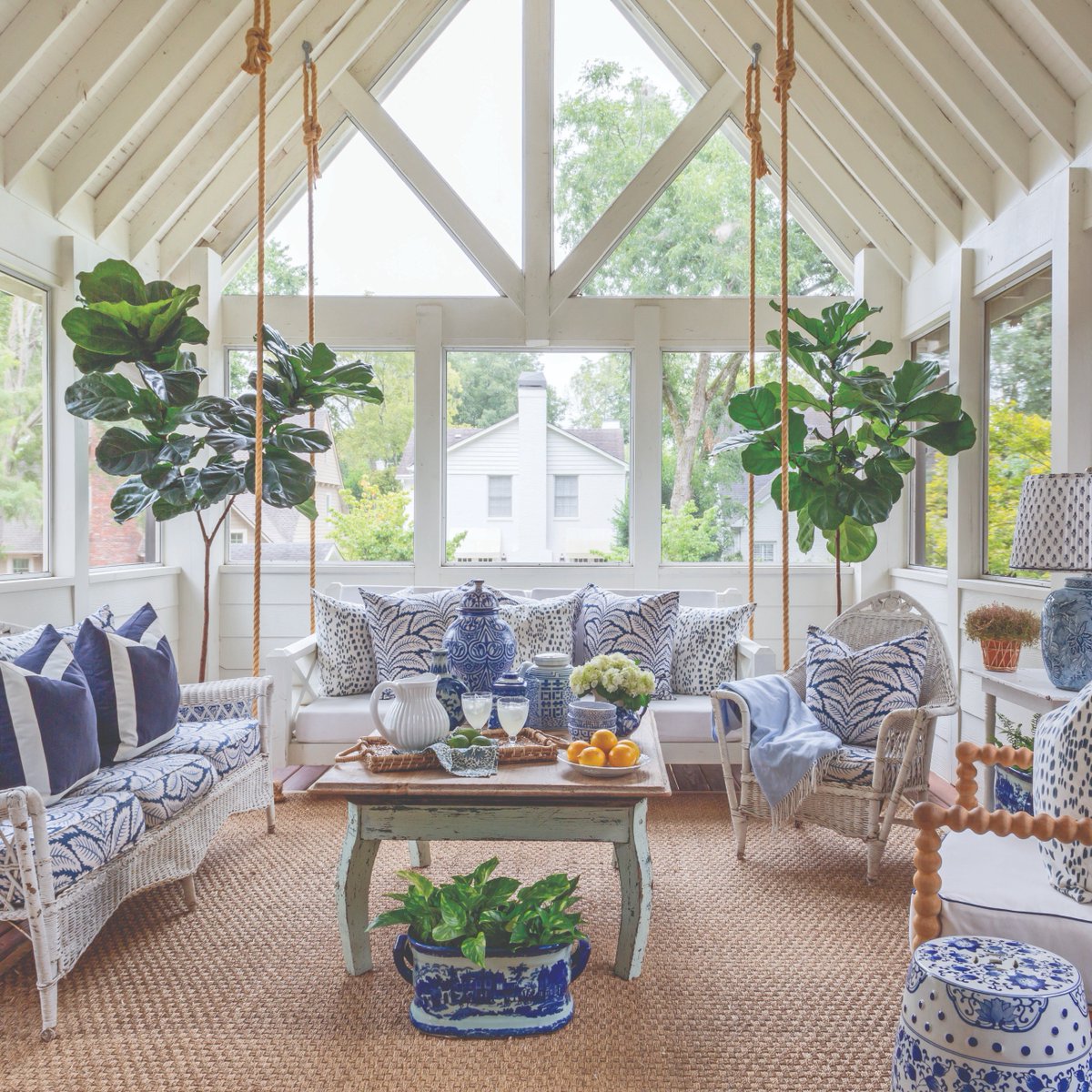 Isn’t this sunroom absolutely dreamy? 😍 Soaring ceilings and cozy furnishings are a match made in heaven, especially when accented with plenty of plants and classic blue-and-white flair.

#southernladymag #sunroom #porch #outdoorliving #blueandwhite #chinoiserie #grandmillennial