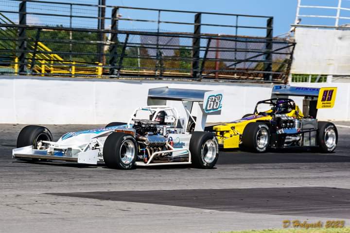 Michael Barnes in the always beautiful and always fast Syrell 68 and Jerry Curran in the Nuclear Banana 99 2023 @OswegoSpeedway Photo: Holynski Racing Photography