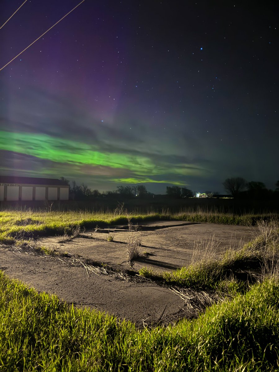 Aurora over a slabbed foundation where a building used to stand before the tornado