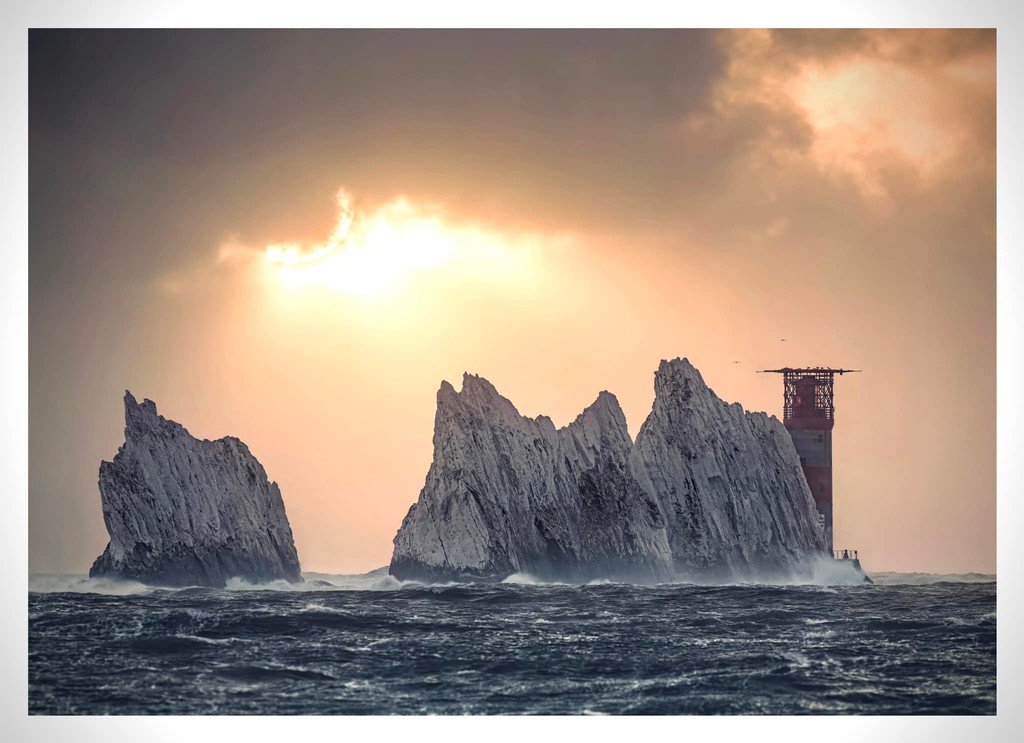 A throwback from Tom... Sunset poking through the clouds 🌞 ⁠ 📌 The Needles: Landmark Attraction⁠ 📷️ Tom Packham Photography ⁠ #exploreisleofwight #isleofwight #myisleofwight #IOW #WestWight #TheNeedlesLandmarkAttraction #dramatic #seascapephotography #sunset #clouds