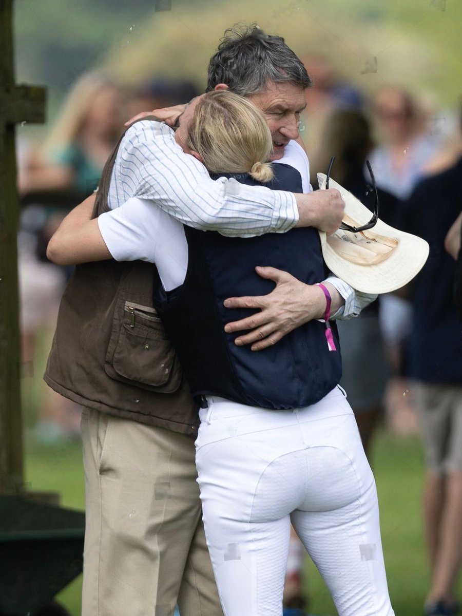 Tim Laurence giving Zara Phillips a piggyback at the beach near Sandringham in 1987. 37 years later, Sir Tim Laurence hugging his stepdaughter Zara Tindall after she completed the cross country course at the Badminton Horse Trials in 2024 🥹