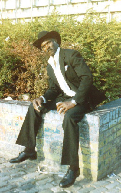 Photograph Hulme Carnival 1984 The coolest man in the universe pops out for the day in all his finery. Don't remember his name but he had a thing about dressing cowboy style, shoelace ties and the like... #Hulme #mossside #hulmecarnival