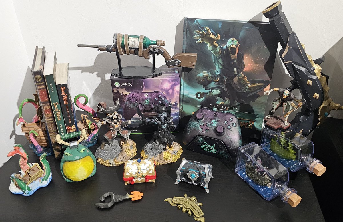 Some of my official and unofficial @SeaOfThieves merch! 

My favourites have def gotta be the controller, art book and shadow Flameheart ❤️‍🔥😍 

What is your favourite SoT merch official or Unofficial? 
#SeaOfThieves #BeMorePirate