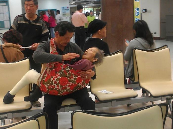A son caring for his elderly mother.