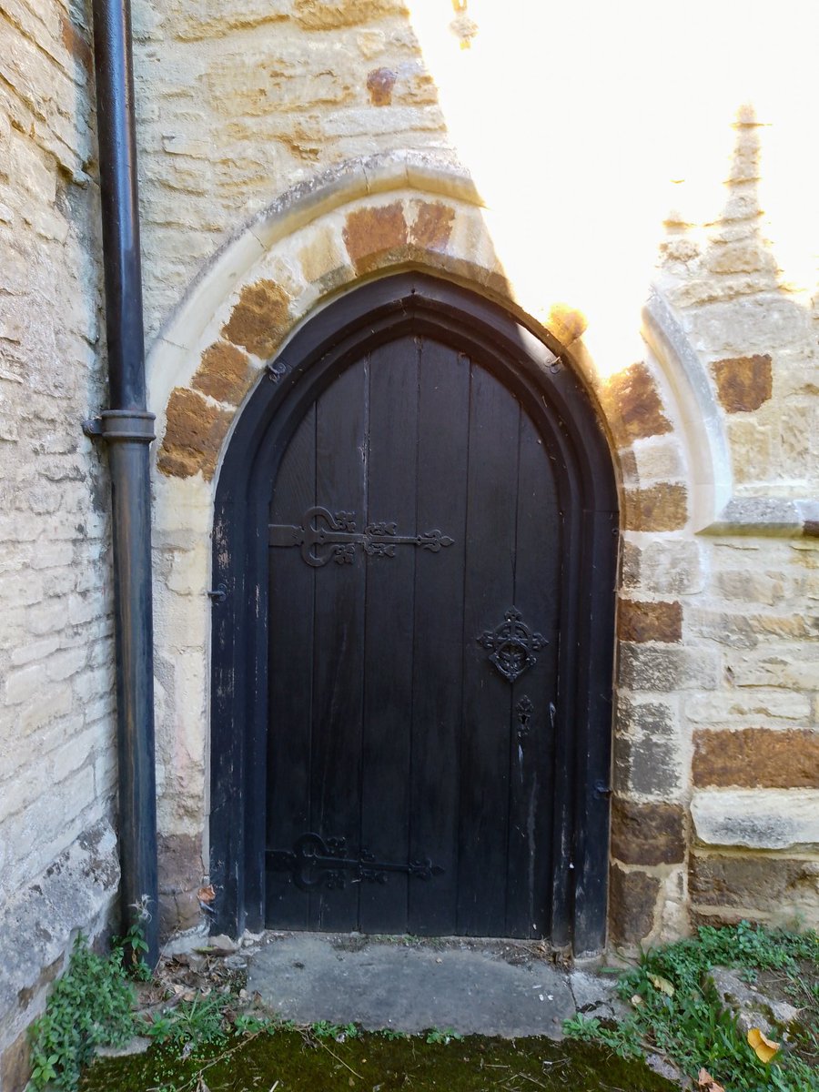 A Southern door of 
 #StPetersIrthlingborough on a bright Morning #PhilOnaBike (2023) #Dailydoor #StoneworkSunday #WoodenWednesday #AdoorableThursday