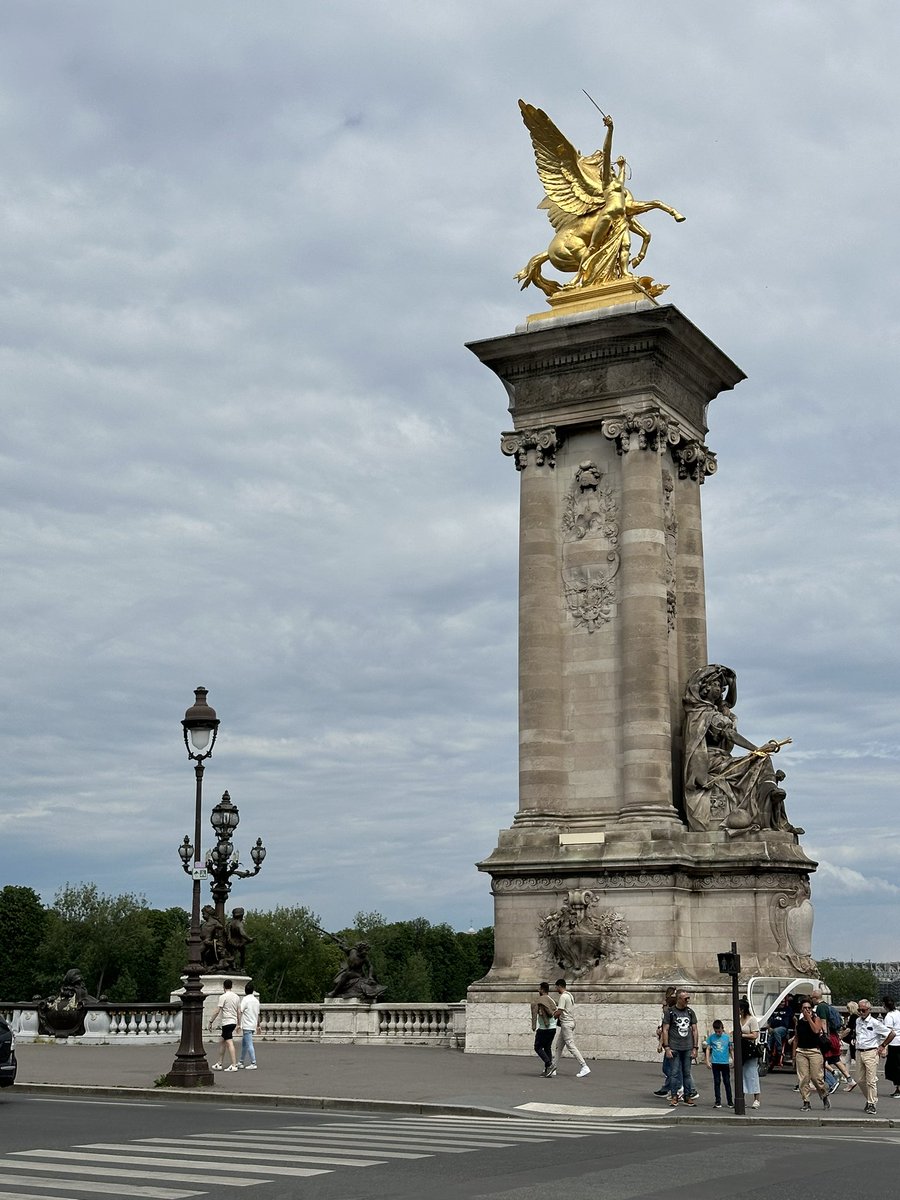 The column heavily decorated by various sculptures of the bridge of Alexander the 3rd in Paris. The bridge was a diplomatic present from the Russian tsar to France for the world exhibition in 1900