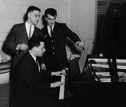 '63: Life at GSC (now Rowan Univ.) was interesting. Standing w/Thom is Bob Moffa. Pat Spino is at the piano. We roommates held a concert of our compositions called 'A Festival of Contemporary Music.' See the 'Thom & Lorry's Lives Together' slideshow here: thomgambino.com/photos