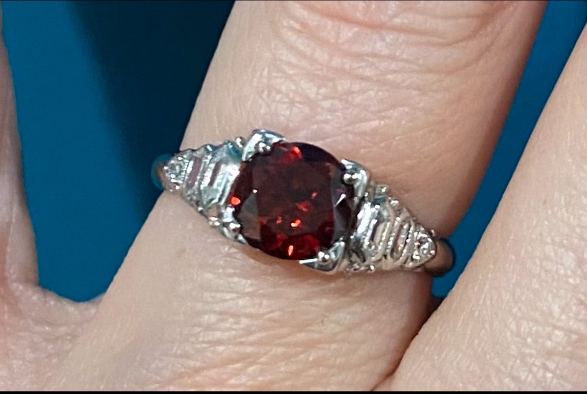 A short story. On the left is my engagement ring from the marriage to an abuser. On the right is the same ring after I sold the diamond, used the money to by smaller diamonds for the two women who helped me escape the DV, and replaced it with my birthstone. A garnet. The end.