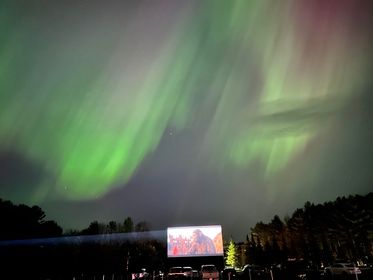 I have seen a lot of great photos of the Northern Lights, but the best is this one Bridgton Twin Drive-In posted of the lights over a screening of Kingdom of the Planet of the Apes.