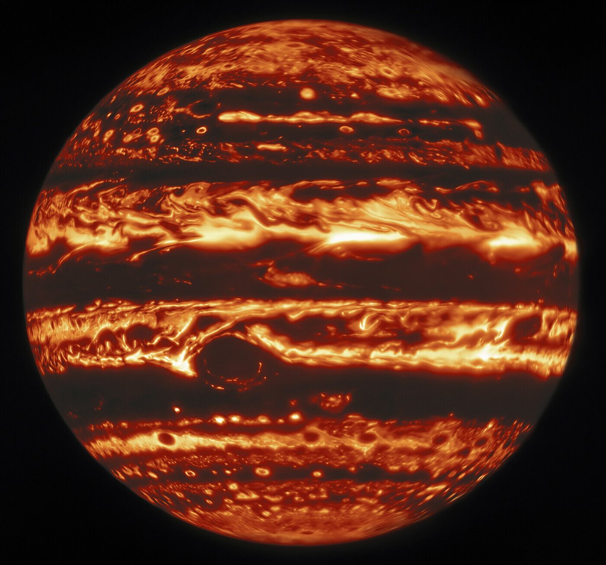 Jupiter in the infrared. 👀 Warmer regions appear brighter, with the Great Red Spot visible as a darker circle near the middle of the image. 📸: Taken by the Near-InfraRed Imager at the Gemini North telescope in Hawaii.