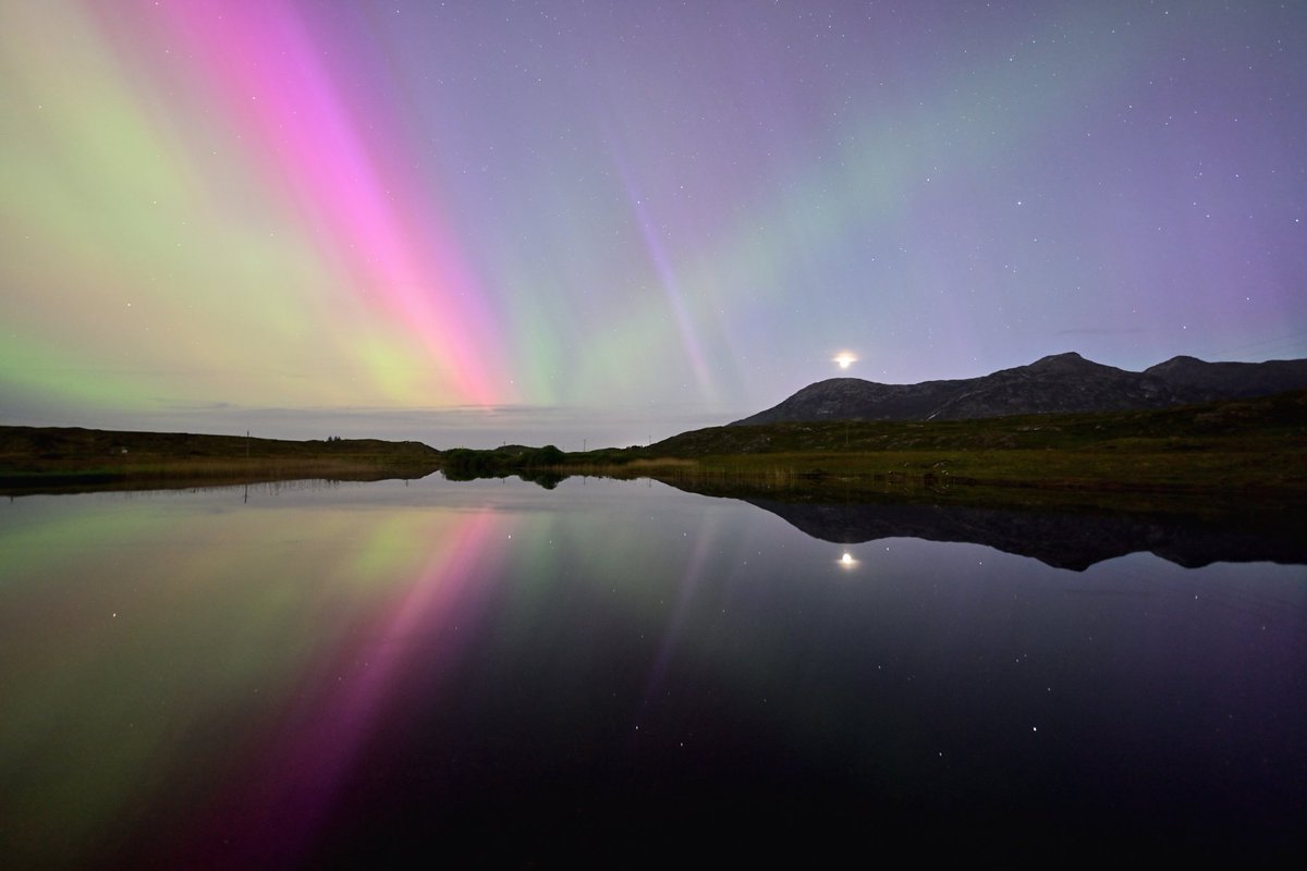 Perfect reflection of the moon and aurora colours over Derryclare Lough, Connemara, Galway