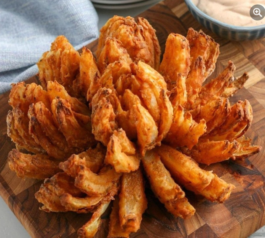 'Craving something crispy and flavorful? Try our recipe for a Delicious Flowering Onion! It's a fun and impressive appetizer that's perfect for sharing. #Appetizer #OnionBlossom #DeliciousEats'