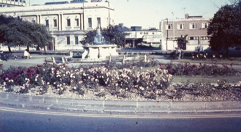 Rose garden and fountain. Lord Louis pub and bus station behind. The fountain is today in front of the library/art gallery.