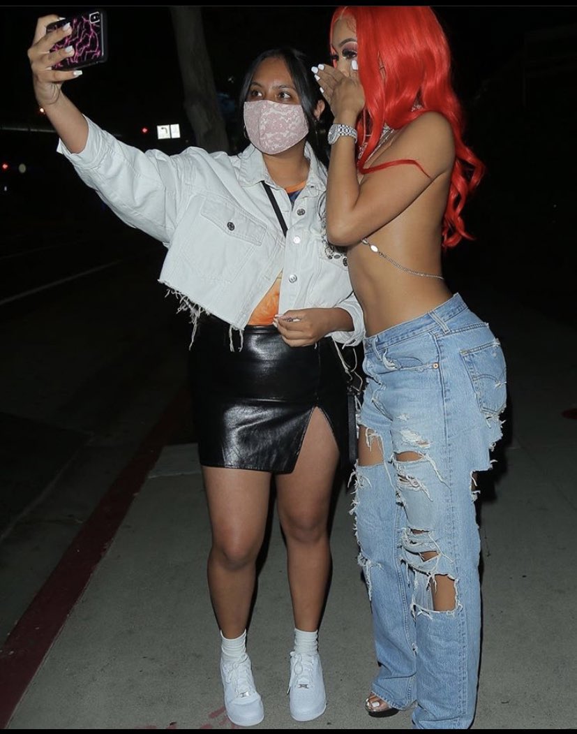 Saweetie using her hand as a mask while meeting fans