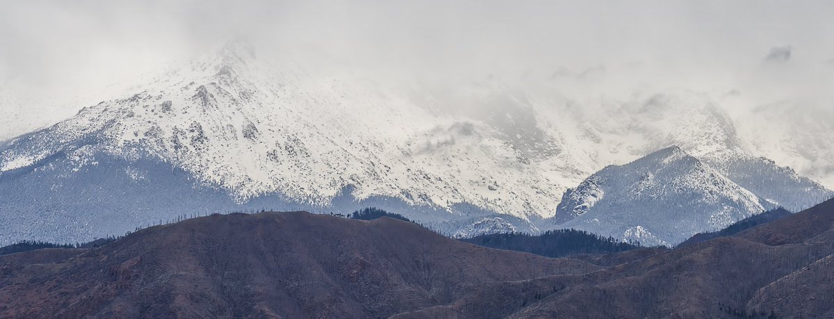 Pikes Peak covered with snow and clouds. ##Colorado #cowx #snowhour #photography