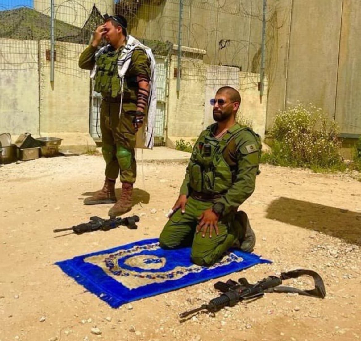 A Jewish IDF soldier and a Muslim IDF soldier praying together and defending their country together. This is the Israel Defense Forces.