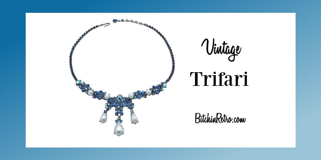 Fabulous #Trifari necklace with aurora borealis pale blue rhinestones, faux pearl cabochons & dangles. Very elegant and regal design. This mark was first used in 1960 for a short period of time.

#vintage #vintagecostumejewelry #vintagestyle #bitchinretro

bitchinretro.com/products/trifa…