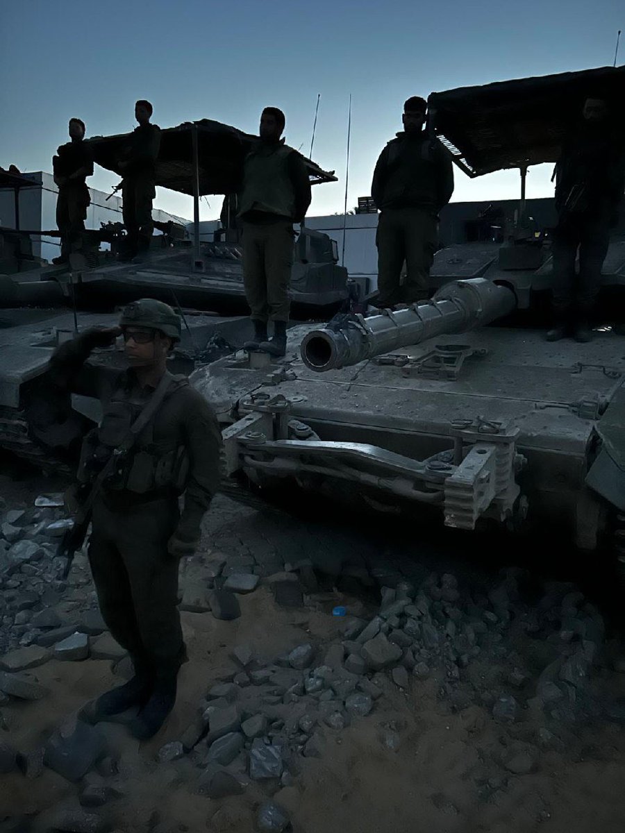 Israeli soldiers stand at attention as the siren sounds in Rafah marking the beginning of Memorial Day for Fallen Security Forces and Victims of Terror