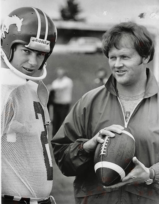 Kicker J.T. Hay and Assistant Coach Stan Schwartz chat during Calgary Stampeders practice in 1980. Hay played 1979-88 and Schwartz coached for 8 years before going to the front office for 3 decades including president. Both are on Stamps Wall of Fame. Schwartz is also in CFHOF.
