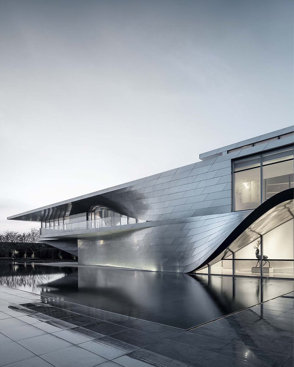 Nanjing Art Center, parametrically designed by @link_arc, is located at the southernmost tip of Nanjing Xincheng, where three rivers intersect to create a landscape called “Fish Mouth.”

The project fuses architecture and landscape to create a public space with an iconic presence
