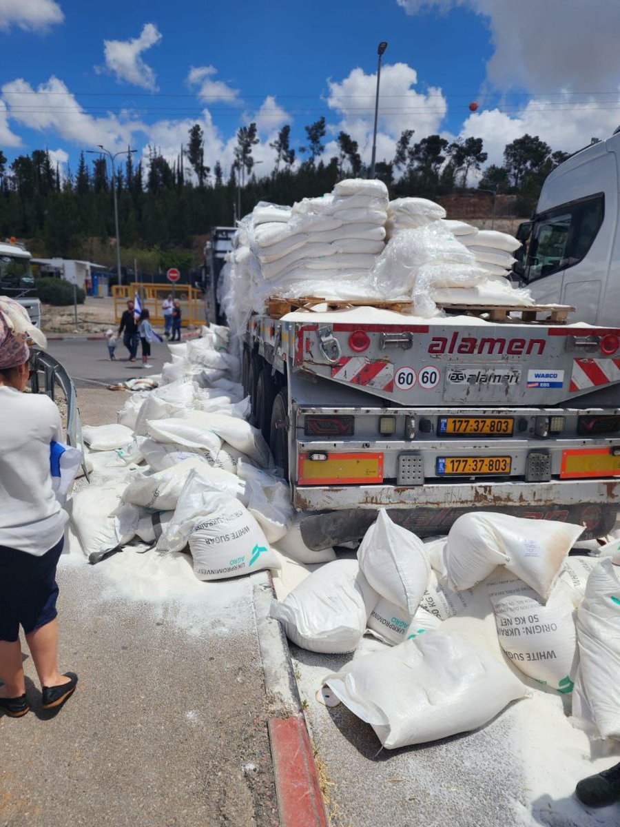 BREAKING: Rampaging Israeli settlers attack trucks carrying desperately needed humanitarian aid on the way to the besieged Gaza Strip, unloading and destroying bags of wheat flour.