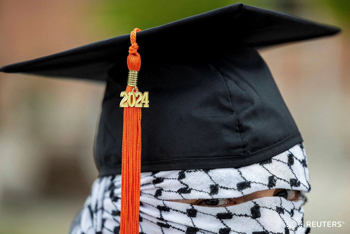 A Palestinian student, who plans to return to his homeland after graduation and who wishes to remain anonymous, poses for a portrait while wearing a keffiyeh along with his commencement cap and 2024 tassel, at the Auraria Campus in Denver, Colorado, U.S. REUTERS/Kevin Mohatt