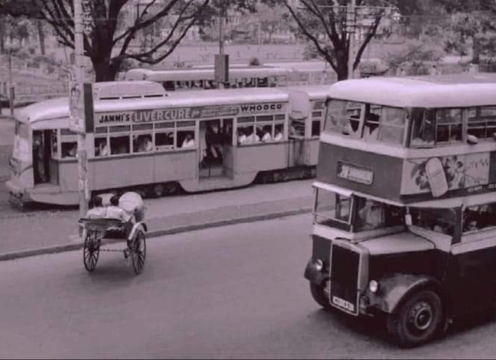 1960: Bus and tram in the frame in Calcutta as it then was. cc. @IndiaHistorypic