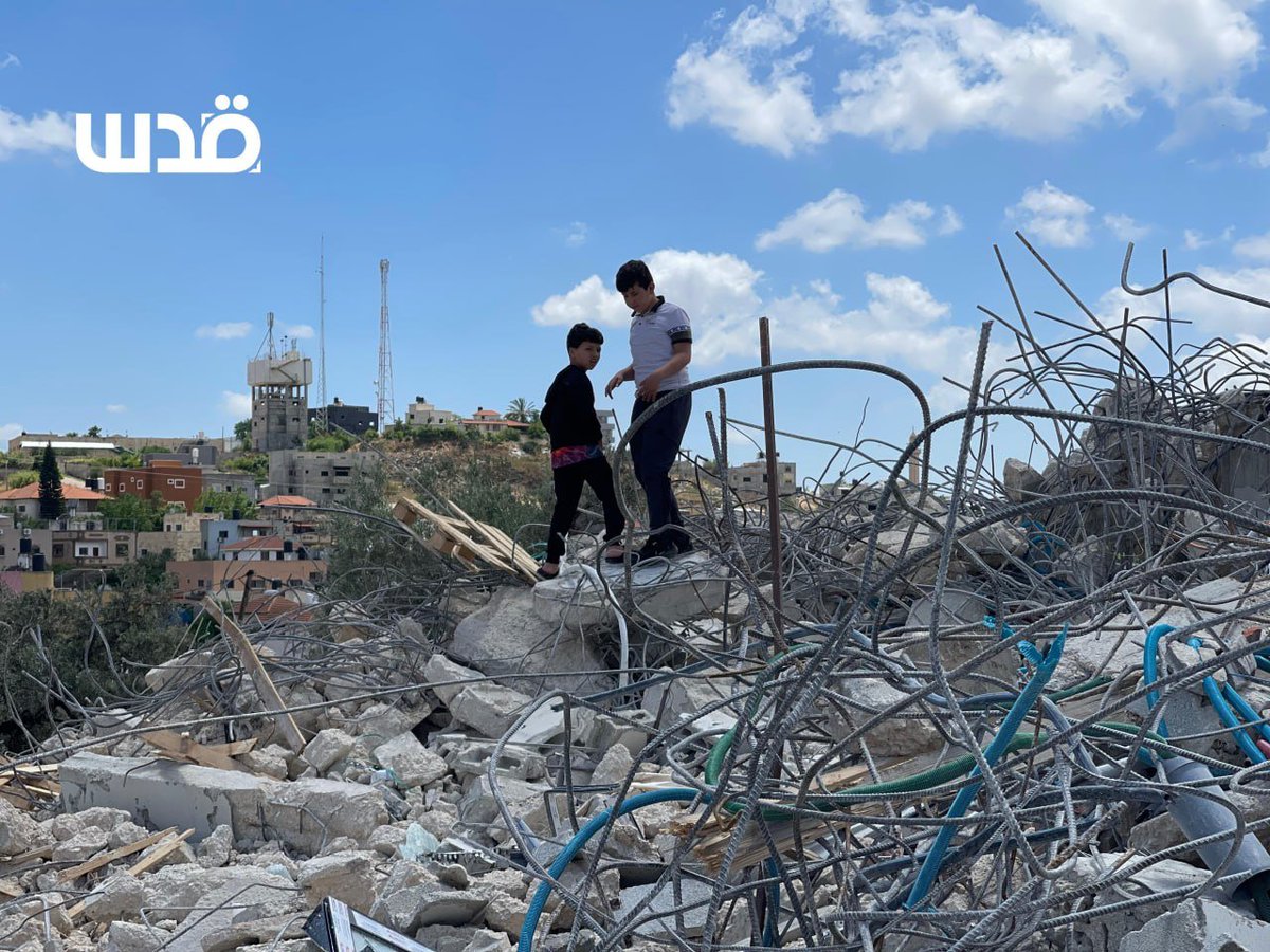 Palestinians inspect the rubble of two homes that were levelled to the ground this morning by Israeli occupation forces in the town of Azzun, north of the occupied West Bank.