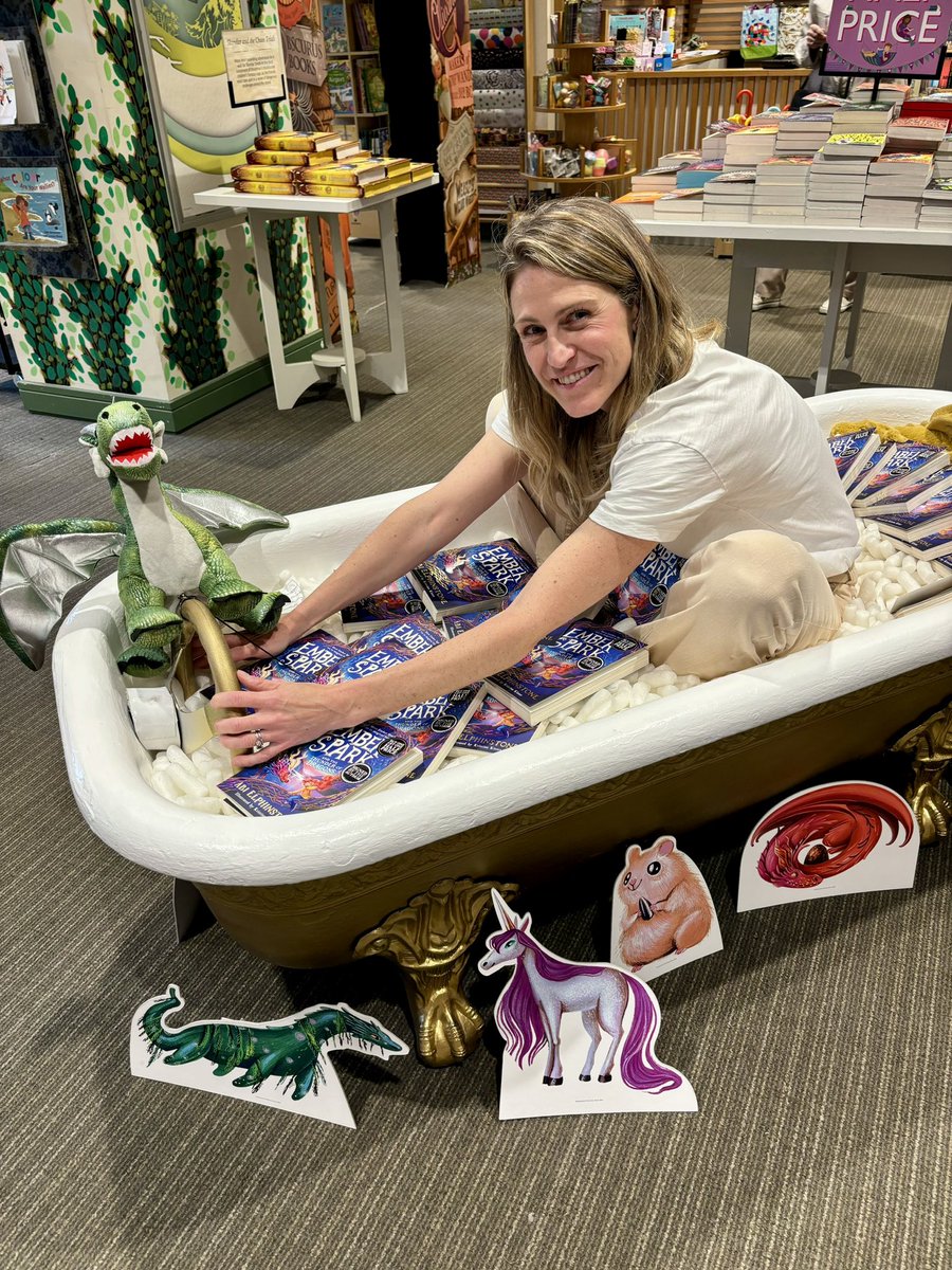 OH MY WORD. As PR stunts go, this is very cool! An EMBER SPARK golden bathtub, complete w/ steering wheel & baby dragons, in @Waterstones_Edi 💥 Thanku @WhatTheFricker for making this happen! And to ace bookseller Morag for letting me climb in while customers looked on, baffled