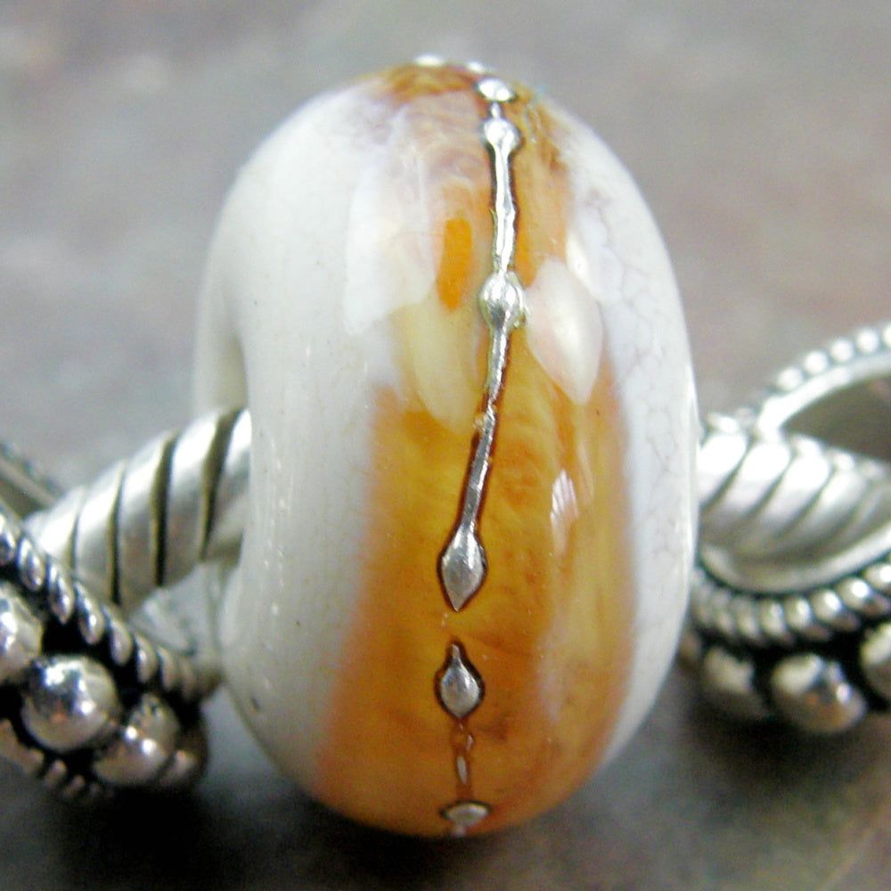 Ivory handmade large hole lampwork glass bead with a transparent light amber topaz band wrapped in fine silver bit.ly/IvoryLtAmberBa… via @Covergirlbeads #ccmtt #LargeHoleBeads #BraceletBeads
