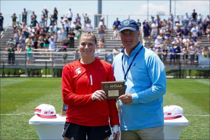 AHSAA Soccer Spotlight presented by Andrews Sports Medicine & Orthopaedic Center Mountain Brook goalkeeper Laine Minich is presented the 6A girls’ state tourney MVP award by Huntsville Sports Commission Executive Director Mark Russell (AHSAA PHOTO | David Holtsford)
