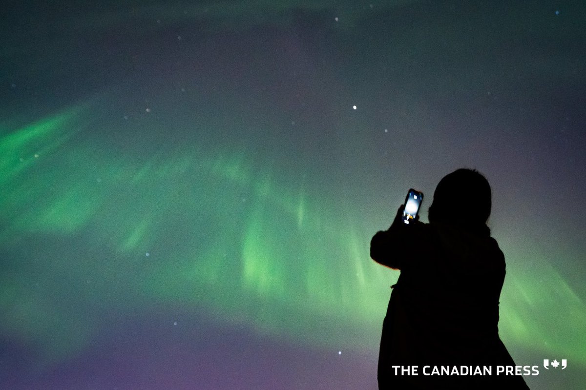 In today’s CP Image (bit.ly/cpimagestw), a person takes a photo of Aurora Borealis or the Northern Lights in Vancouver, B.C., Saturday, May. 11, 2024. THE CANADIAN PRESS/Ethan Cairns